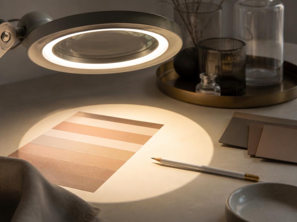 Clinical magnifying lamp illuminating skin tone references for pigmentation assessment